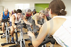 Group Taking Part In Spinning Class In Gym