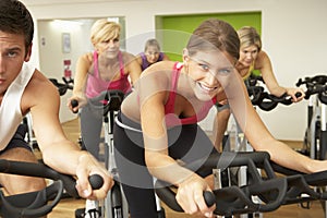 Group Taking Part In Spinning Class In Gym