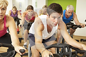 Group Taking Part In Spinning Class In Gym