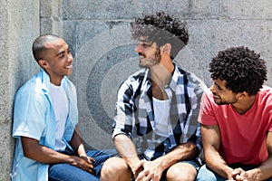 Group of talking african american and caucasian hipster man