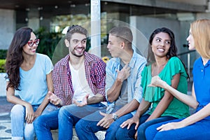 Group of talking young adult men and woman