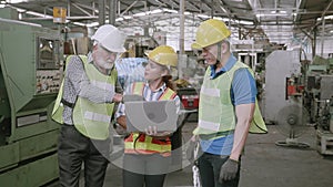 Group of team engineer meeting in industrial factory, foreman and labor talking and using laptop computer.