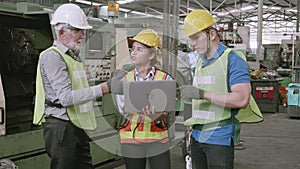 Group of team engineer meeting in industrial factory, foreman and labor talking and using laptop computer.