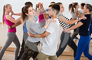 Group of teen dancing salsa in dance studio