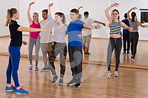 Group of teen dancing salsa in dance studio