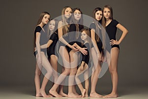 The group of teen girls posing at white studio