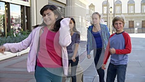 Group Of Teenage Children Posing For Camera In Slow Motion