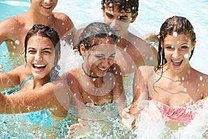 Group Of Teenage Friends Having Fun In Swimming Pool