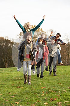 Group Of Teenage Friends Having Piggyback Rides