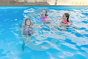 Group of 3 teenage girlfriends having fun in swimming pool