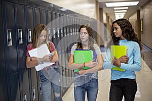 Group of teenage girls walking together in the hallway at junior high school