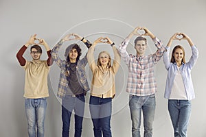 Group of teenage student showing love sympathy make heart gesture studio shot