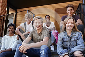 Group Of Teenage Students Socialising On College Campus Together photo