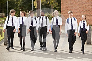 Group Of Teenage Students In Uniform Outside School Buildings