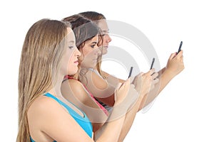 Group of teenager girls obsessed with the smart phone photo