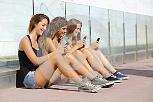 Group of teenager girls texting on smart phone