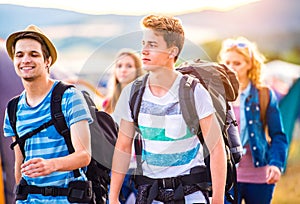Group of teenagers with backpacks arriving at music festival