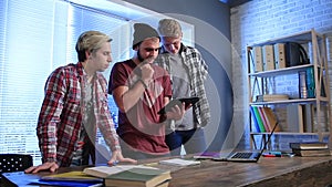 Group of teenagers in classroom with a tablet pc