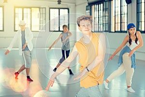 Group teenagers dancing hip-hop indoors