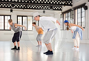 Group teenagers dancing hip-hop indoors