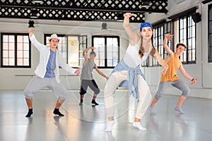 Group teenagers dancing hip-hop indoors