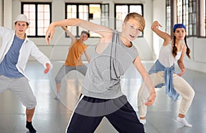 Group teenagers dancing hip-hop indoors