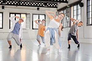 Group teenagers dancing hip-hop indoors