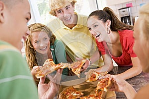 Group Of Teenagers Eating Pizza