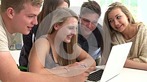 Group Of Teenagers Gathered Around Laptop Together