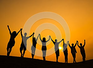 Group of Teenagers Holding Hands and Celebrate in Back Lit