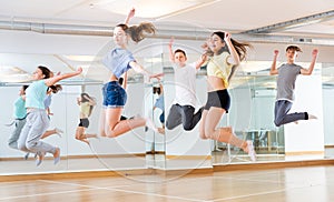 Group of teenagers jumping during dance workout