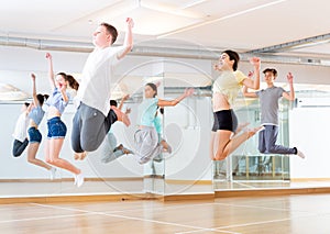 Group of teenagers jumping during dance workout