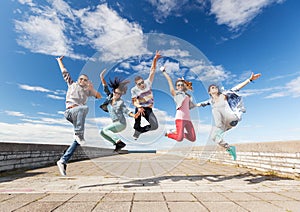 Group of teenagers jumping photo