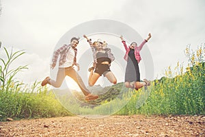 Group of Teenagers Jumping at yellow flower field,enjoying with