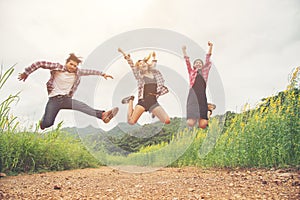 Group of Teenagers Jumping at yellow flower field,enjoying with