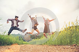 Group of Teenagers Jumping at yellow flower field,enjoying with