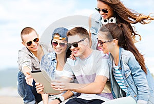 Group of teenagers looking at tablet pc