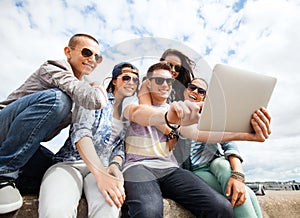 Group of teenagers looking at tablet pc