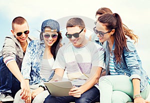 Group of teenagers looking at tablet pc