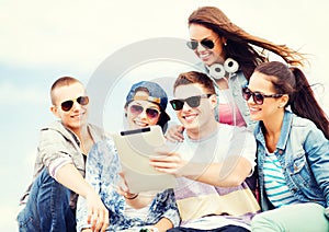 Group of teenagers looking at tablet pc