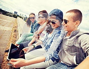 Group of teenagers looking at tablet pc