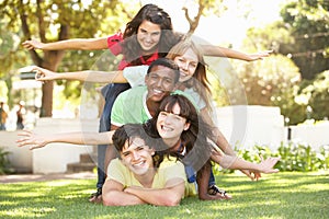 Group Of Teenagers Piled Up In Park photo