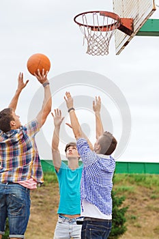 Group of teenagers playing basketball