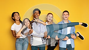 Group of Teenagers Posing for Picture, Holding Their Friend