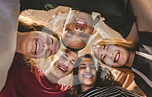 Group of teenagers put their heads together teamwork concept