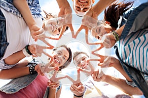 Group of teenagers showing finger five