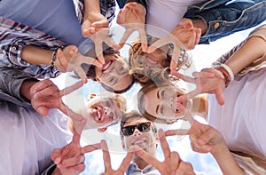 Group of teenagers showing finger five