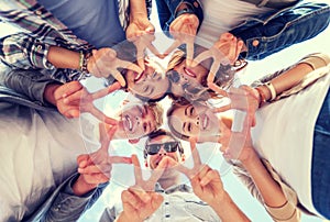 Group of teenagers showing finger five