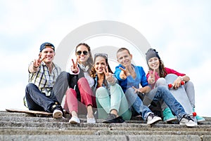 Group of teenagers showing finger five