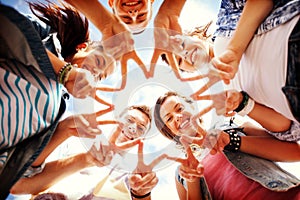 Group of teenagers showing finger five photo